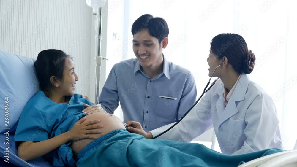 Female doctor visiting to pregnant woman at hospital. Pregnant woman and he husband talking to doctor with happy emotion. People with healthcare and medical concept. Female doctor visiting to pregnant woman at hospital. Pregnant woman and he husband talking to doctor with happy emotion. People with healthcare and medical concept.