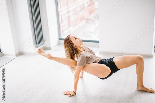 young awesome happy woman developing flexibility. full length photo.yoga practise