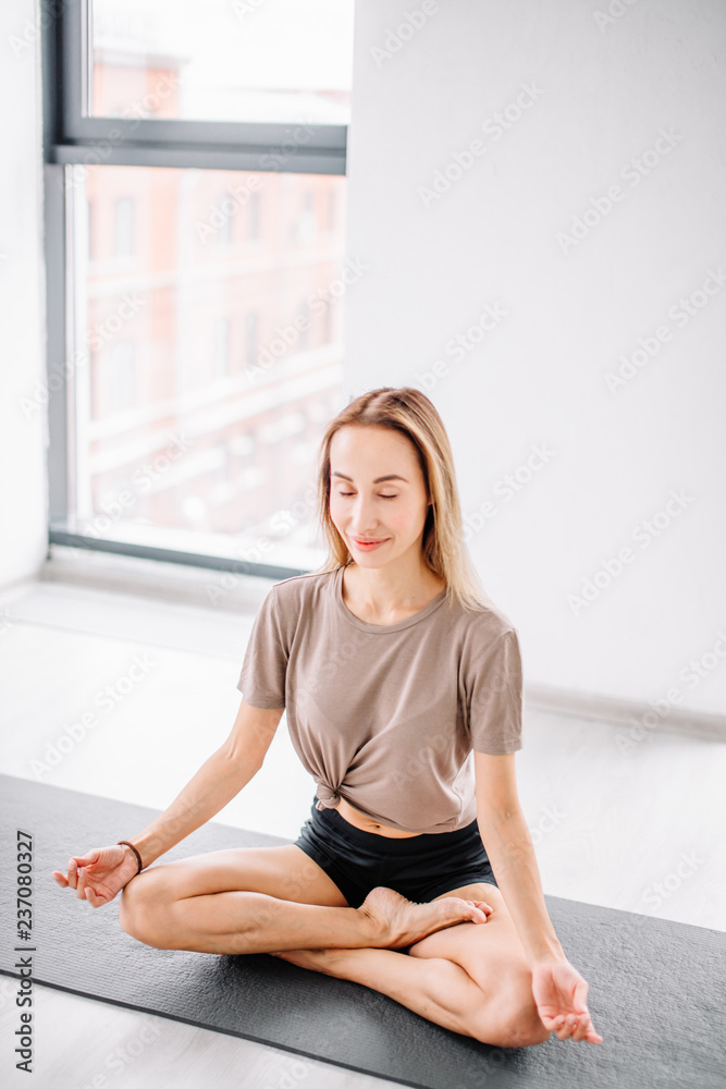 emotional girl concentrated on yoga. full length side view photo. spare time concept. resting time. sport emotional girl concentrated on yoga. full length side view photo. spare time concept. resting time. sport