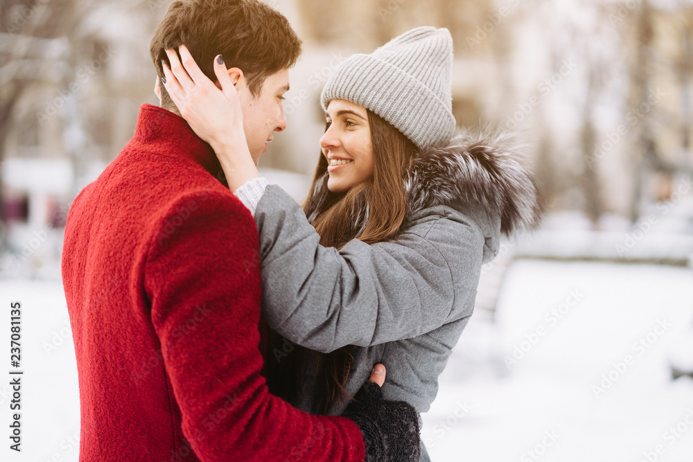 Fototapeta premium A young guy and a girl are hugging each other