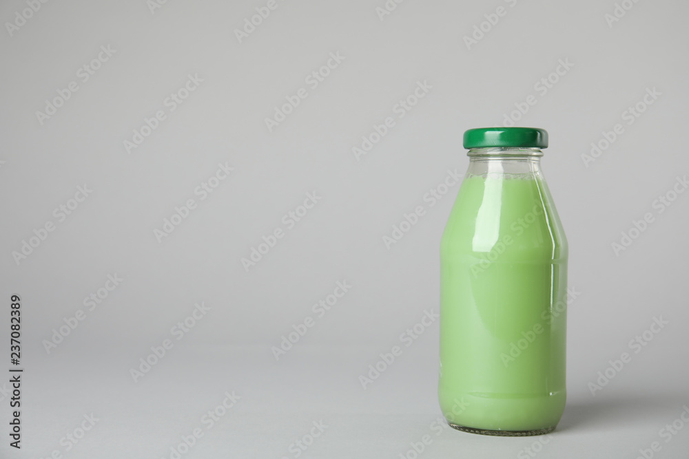 One bottle with tasty drink on color background. Space for text One bottle with tasty drink on color background. Space for text