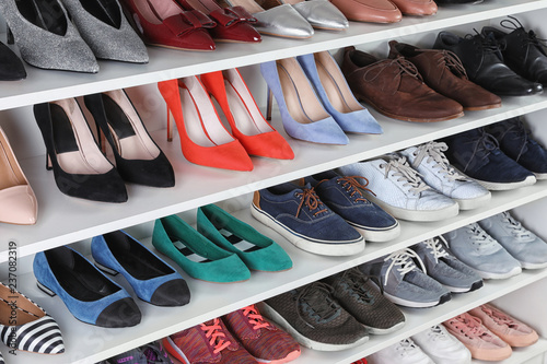 Shelving unit with different shoes. Element of dressing room interior photo