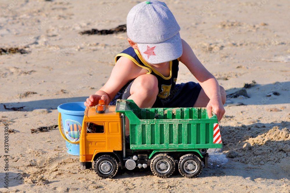 Un petit garçon qui joue sur une plage en Bretagne avec son grand père Un petit garçon qui joue sur une plage en Bretagne avec son grand père