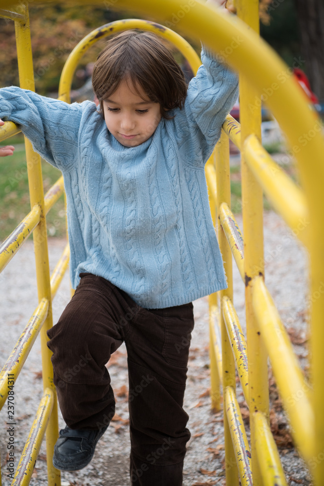 Fototapeta premium cute little boy having fun in playground
