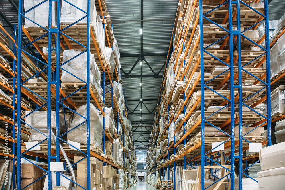 Large Logistics hangar warehouse with lots shelves or racks with pallets of goods