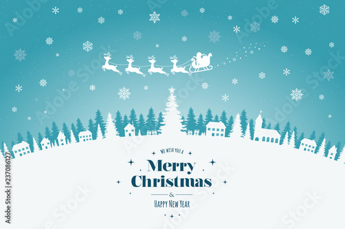 Greeting card with stylish Merry Christmas lettering. In the background, a town in a winter scenery, in the sky a reindeer team with Santa Claus and falling snow