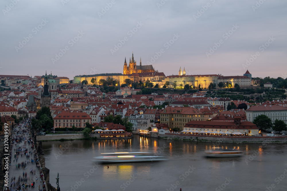 Prague, Czech Republic. Charles Bridge and Hradcany (Prague Castle) with St. Vitus Cathedral and St. George church evening dusk, Bohemia landmark in Praha.