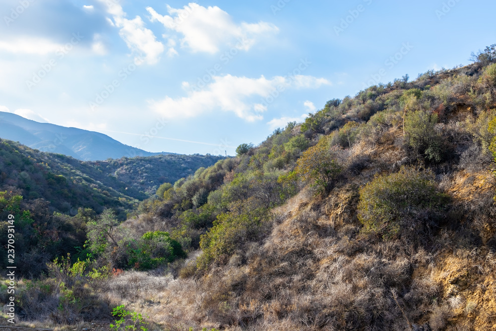 Fototapeta premium Fall hillsides in Southern California mountains with room for copy space in sky