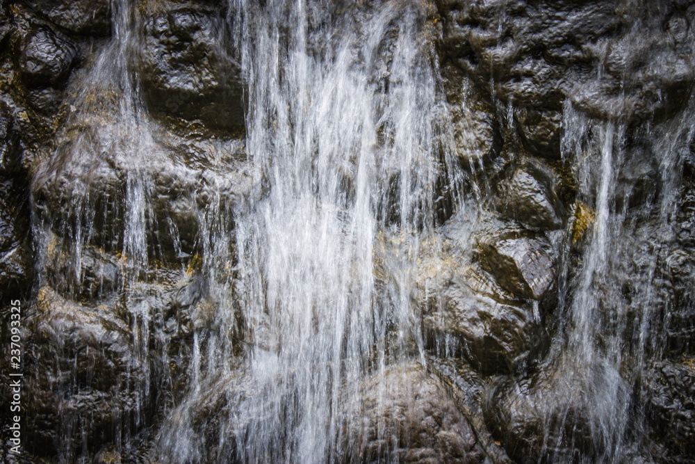 background image of fresh water flowing over a rocky wall background image of fresh water flowing over a rocky wall