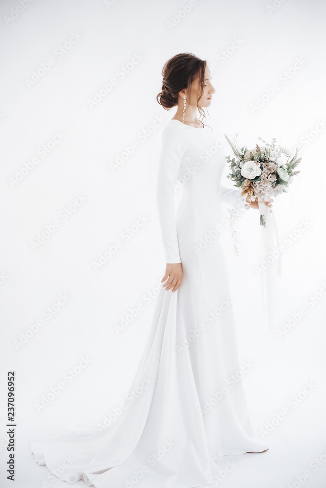 Beautiful brunette bride with stylish make-up in white dress Beautiful brunette bride with stylish make-up in white dress