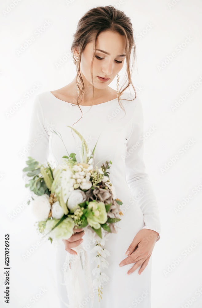 Beautiful brunette bride with stylish make-up in white dress Beautiful brunette bride with stylish make-up in white dress