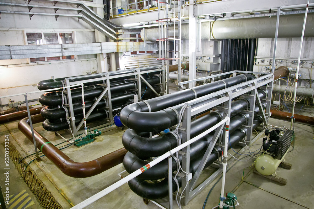Pipes and sewage pumps inside modern industrial wastewater treatment plant Pipes and sewage pumps inside modern industrial wastewater treatment plant