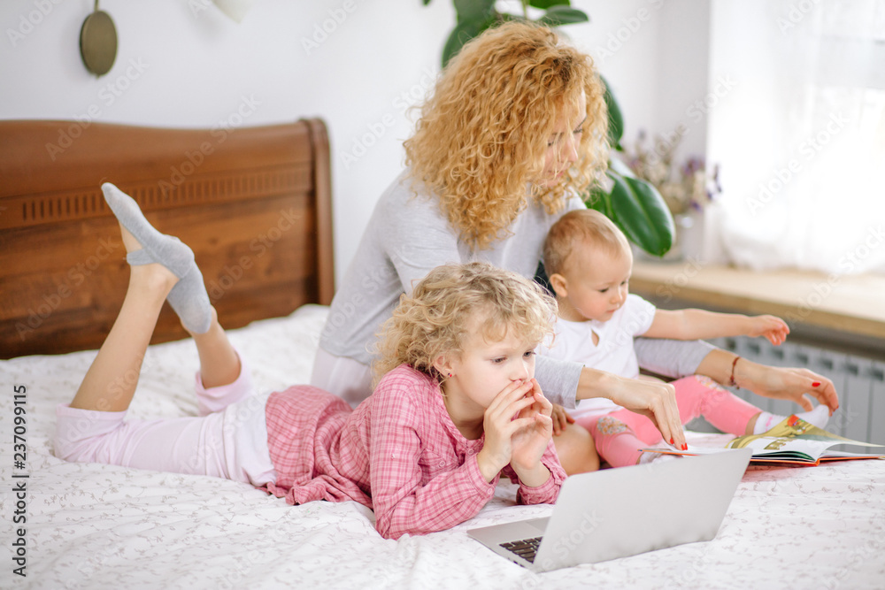 Fototapeta premium holidays with children. useful time with kids. woman terying to give knowledge to her children. side view photo