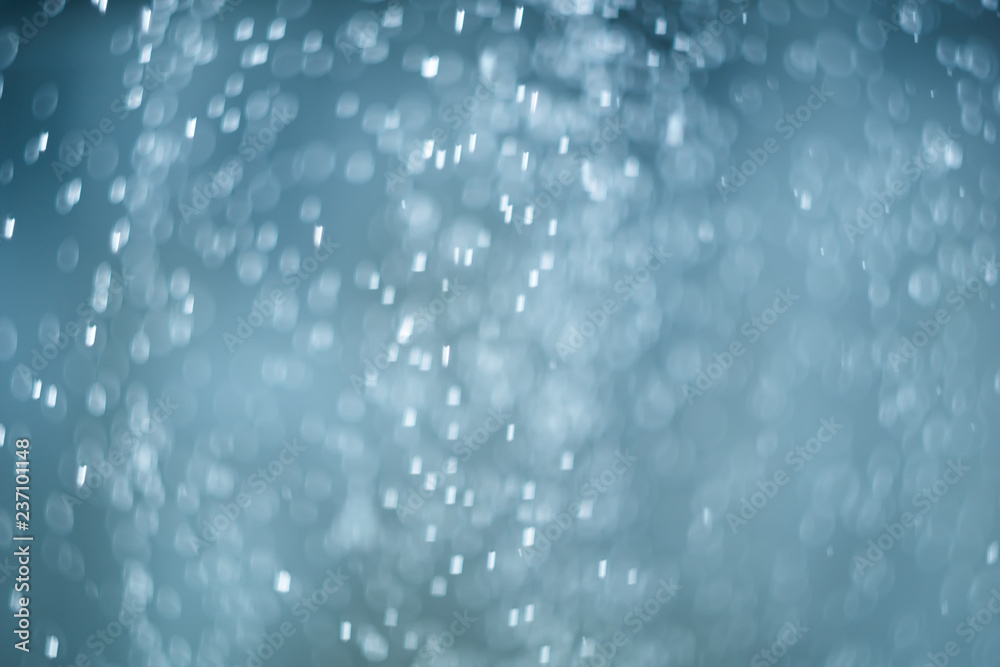 Obraz premium falling snow, abstract blue bokeh background