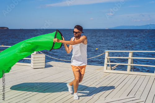 Man tries to inflate an air sofa. lamzac photo