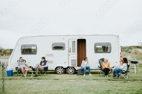 Group of people sitting outside a trailer park photo