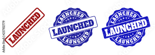 LAUNCHED grunge stamp seals in red and blue colors. Vector LAUNCHED labels with grunge surface. Graphic elements are rounded rectangles, rosettes, circles and text captions.