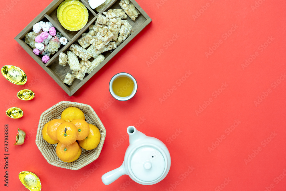 Fototapeta premium Top view aerial image shot of arrangement decoration Chinese new year & lunar new year holiday background concept.Flat lay fresh orange with food & drink on red paper.Other language mean rich or happy