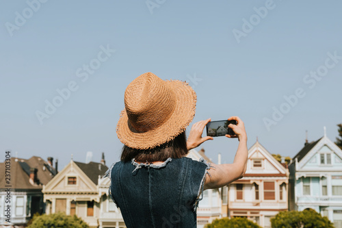 Photography Woman taking a photo of the Painted Ladies of San Francisco, USA