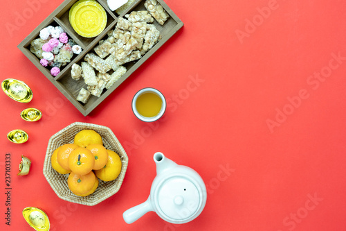 Top view aerial image shot of arrangement decoration Chinese new year & lunar new year holiday background concept.Flat lay fresh orange with food & drink on red paper.Other language mean rich or happy