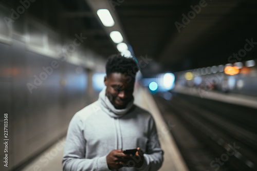 Canvas Print Man texting at a subway station