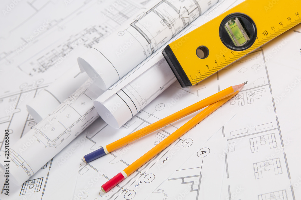 Pencils, spirit level and paper еngineering house drawings and blueprints. Pencils, spirit level and paper еngineering house drawings and blueprints.