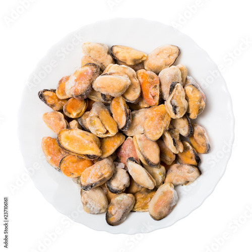Frozen mussels on a white plate, isolated on white background