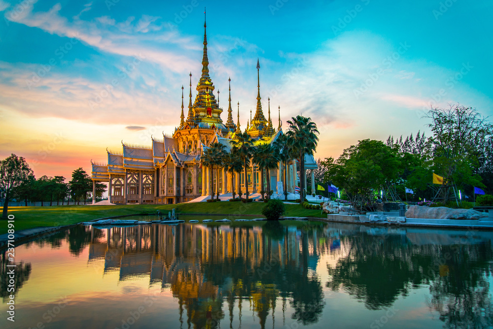 temple thailand / beautiful thailand temple dramatic colorful sky twilight sunset shadow on water reflection - Landmark Nakhon Ratchasima province temple at Wat None Kum in Thailand - obrazy, fototapety, plakaty 