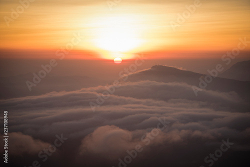 foggy landscape   the morning beautiful sunrise mist cover mountain background - forest hill mist fog flow with wind and orange sky