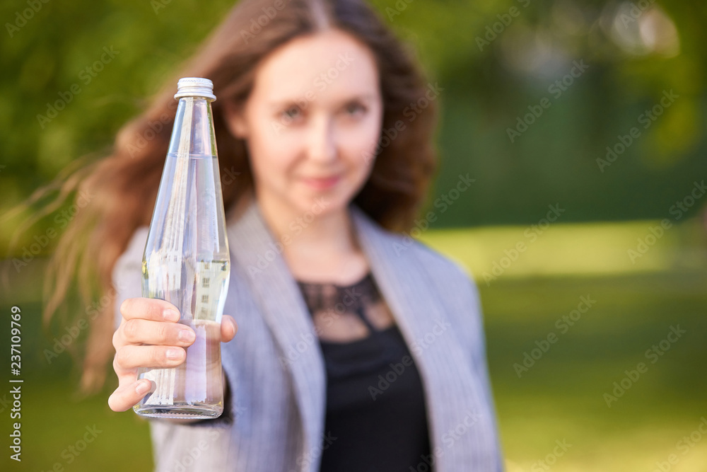 Young woman hold water bottle. Selective focus Young woman hold water bottle. Selective focus