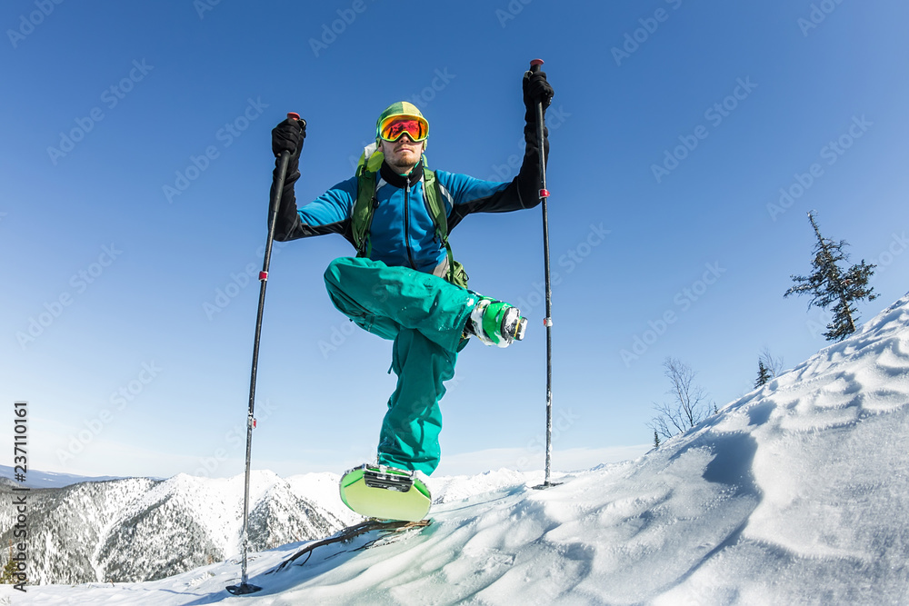 Skier freerider doing yoga skiing in snowy mountains Skier freerider doing yoga skiing in snowy mountains