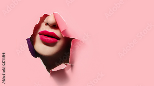 Photo Beautiful red lips in pink paper frame