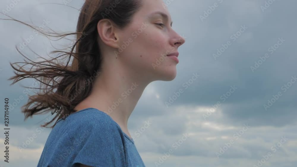 Beautiful girl with streaming hair in slow motion against sea background Beautiful girl with streaming hair in slow motion against sea background