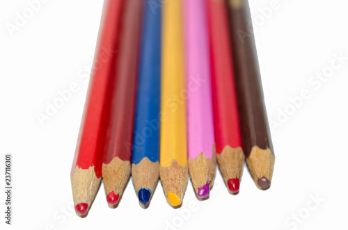 Multicolored pencils on white background