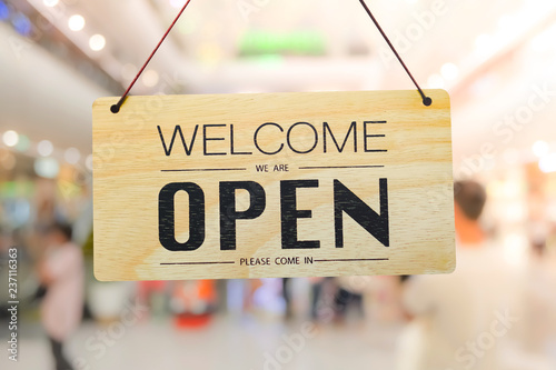 A business sign that says ‘Open’ on cafe or restaurant hang on door at entrance. Vintage color tone style.