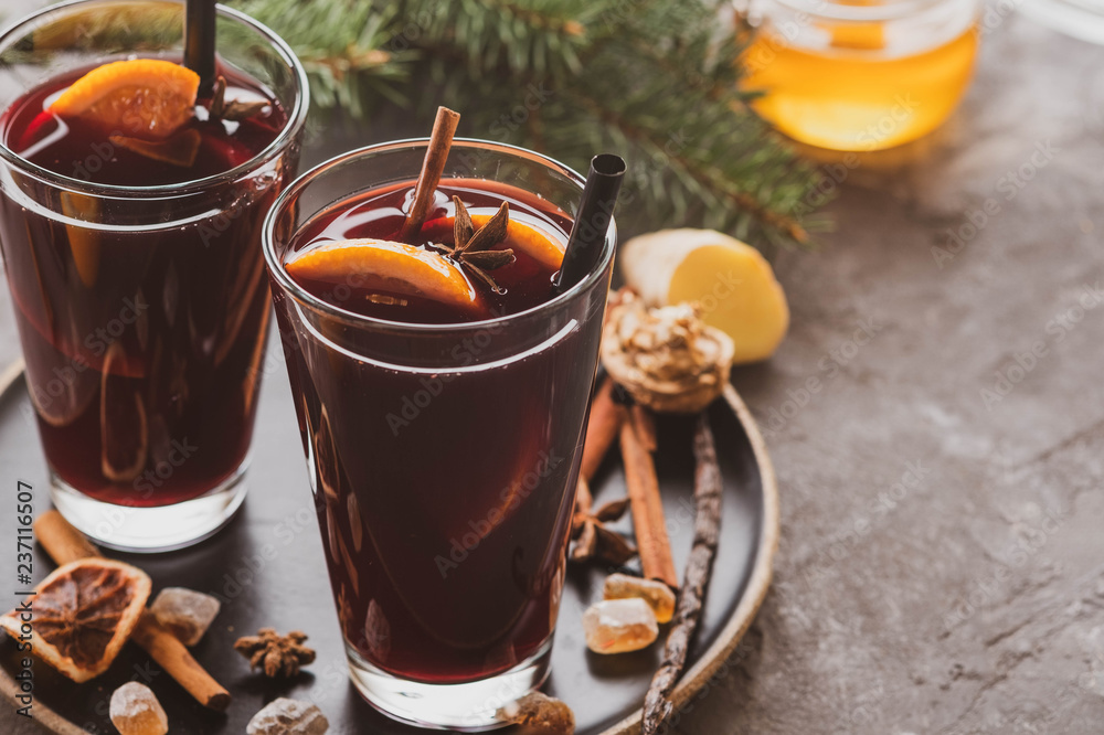Hot mulled wine with spices, apple and orange on chrictmas background. Copy space. Hot mulled wine with spices, apple and orange on chrictmas background. Copy space.