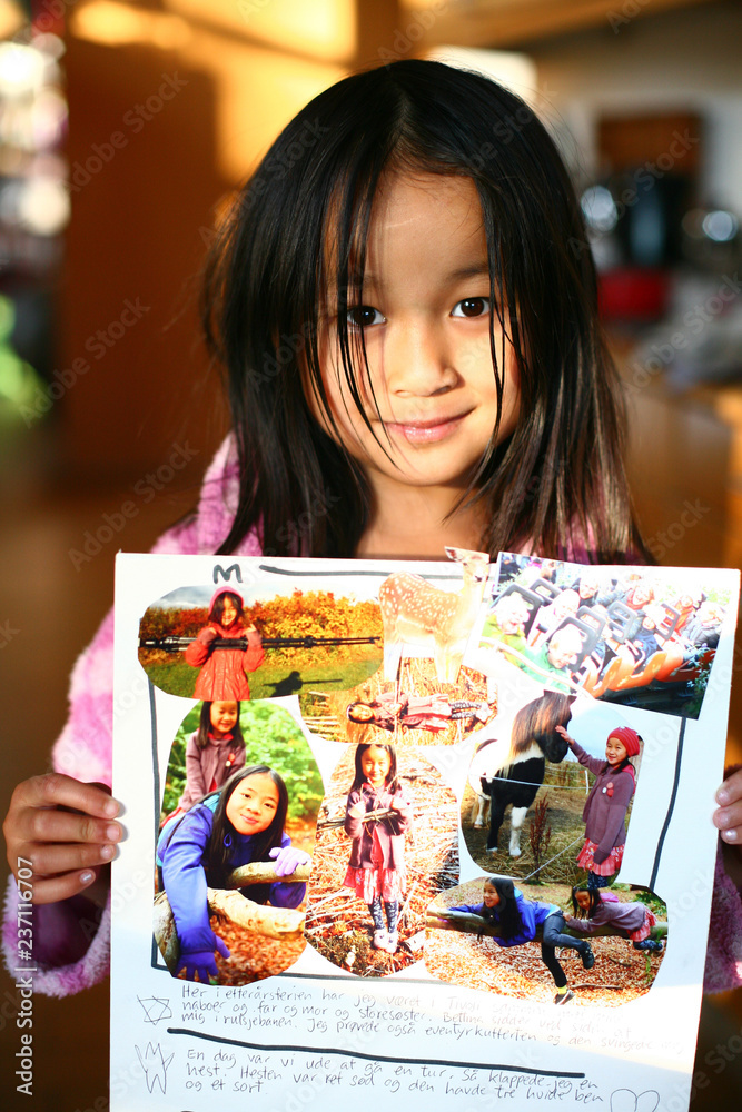 Fototapeta premium Portrait of a young cute girl looking at the camera