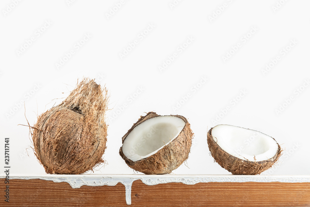 Tropical fruit whole and half abstract background .Coconut on wood table with white background.