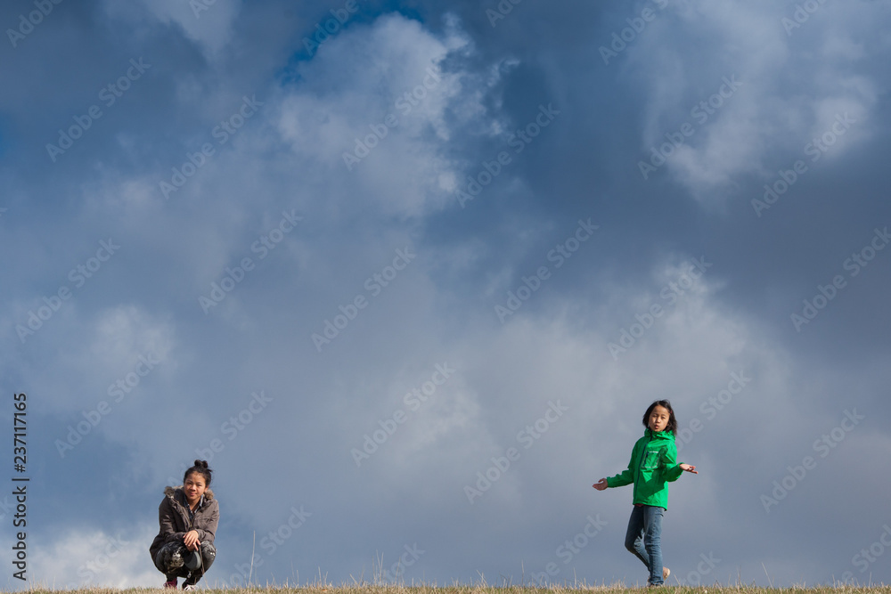 Cute girl running jumping at the on a field in the summer Cute girl running jumping at the on a field in the summer