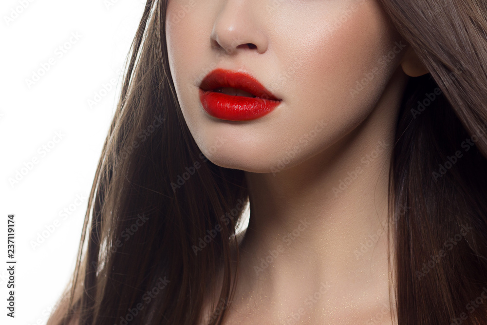 Beauty closeup of women full red lips with shiny skin and long hair. Facial skin care in a spa salon or cosmetology and a fashionable natural lip gloss or lipstick. Day makeup Beauty closeup of women full red lips with shiny skin and long hair. Facial skin care in a spa salon or cosmetology and a fashionable natural lip gloss or lipstick. Day makeup