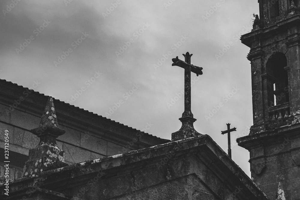 Ancient stone church with tower and crosses dark faded. Medieval monastery details black and white. Mystical exterior of catholic catherdal. Old temple with cross monochrome. Religion concept.