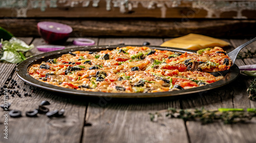 Slice of hot pizza large cheese lunch or dinner  meat  mushroom  topping sauce. with bell pepper vegetables delicious tasty fast food italian traditional on wooden board table. Banner