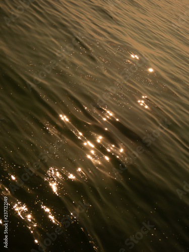 Gold background of night lights seen from above through the clouds photo