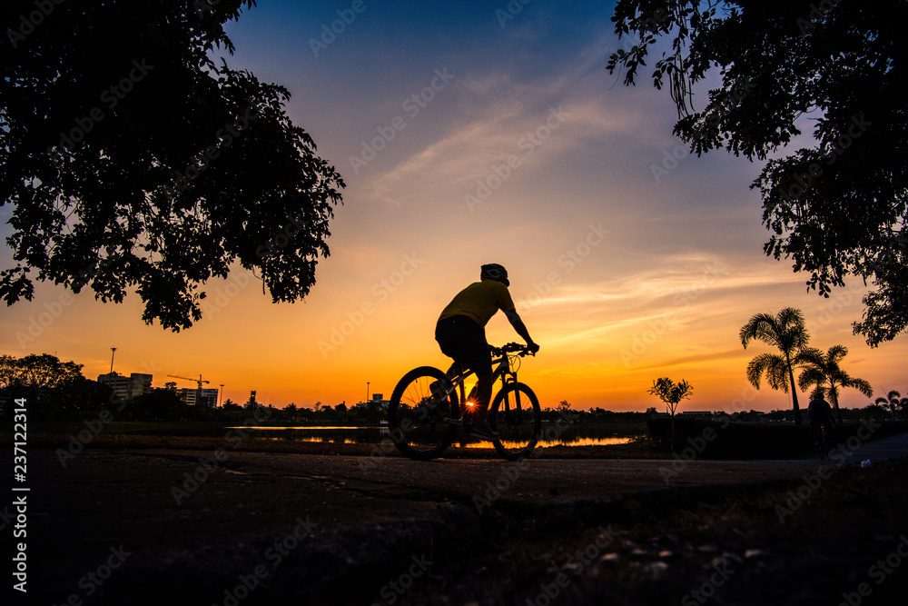 Shadow cyclists exercise in the evening.