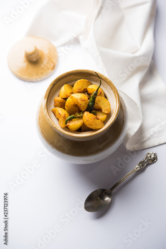 Homemade Gooseberry or amla Pickle/ or Aavle ka Achar in a bowl or barni over moody background.  selective focus
