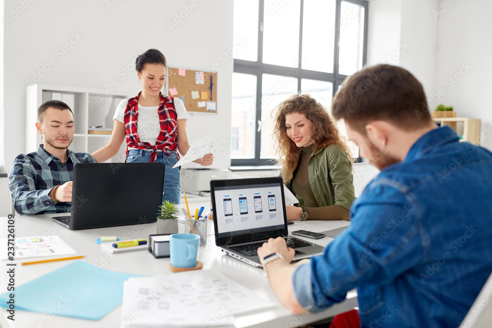 business, technology and people concept - creative team or designers working on user interface at office
