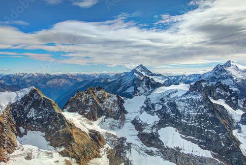 View from the top Mt. Titlis in Switzerland at the middle of October. The Titlis is a mountain, located on the border between the Swiss cantons of Obwalden and Bern. photo