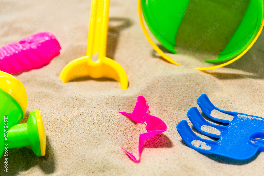 childhood and summer concept - close up of sand toys kit on beach childhood and summer concept - close up of sand toys kit on beach