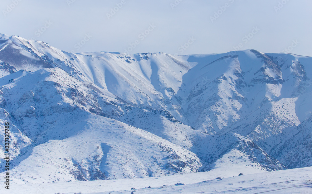 White snow on the mountainside as a background