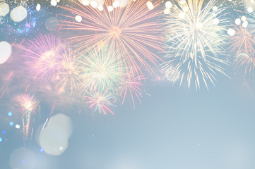 Fireworks colorful explosions on blue, festive background with copy space